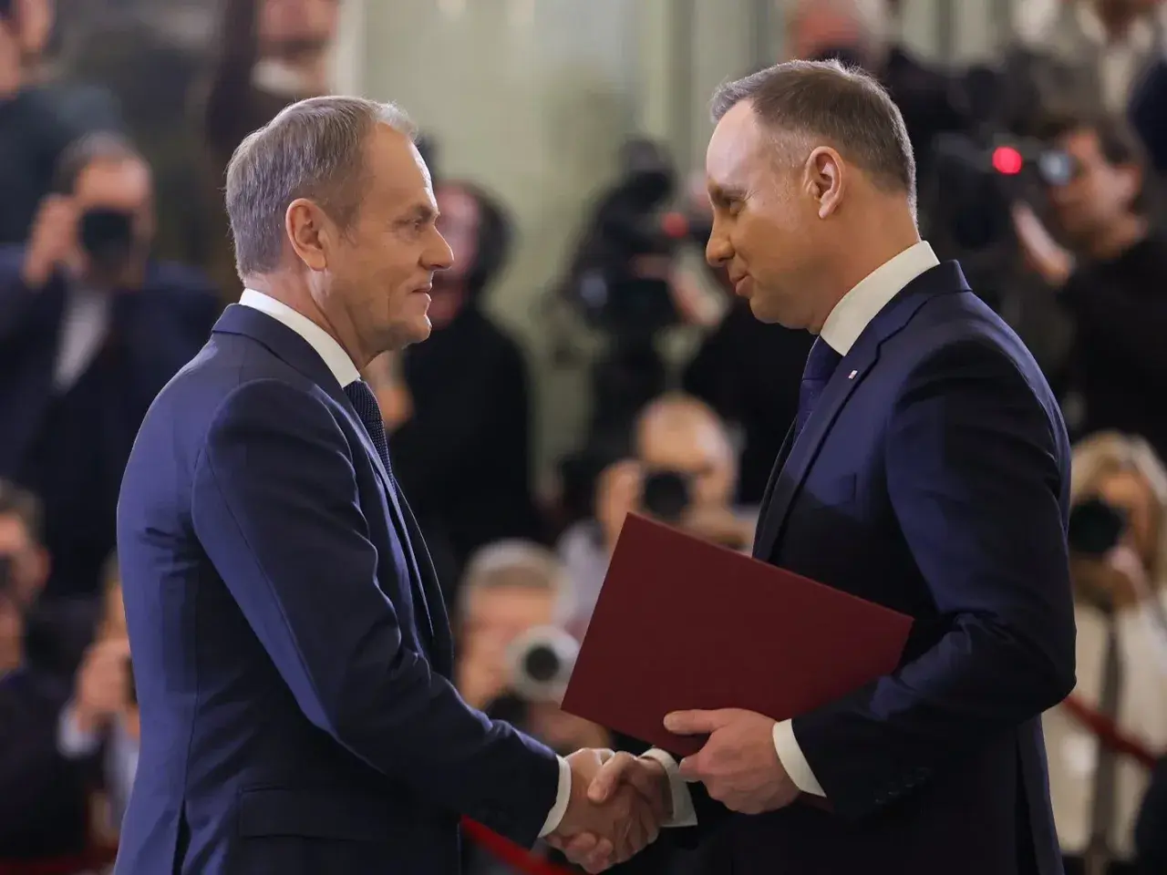 Andrzej Duda i Donald Tusk uścisnęli sobie dłonie, dyskutując o obronności. Prawda o ich rzekomym pakcie wciąż budzi emocje.