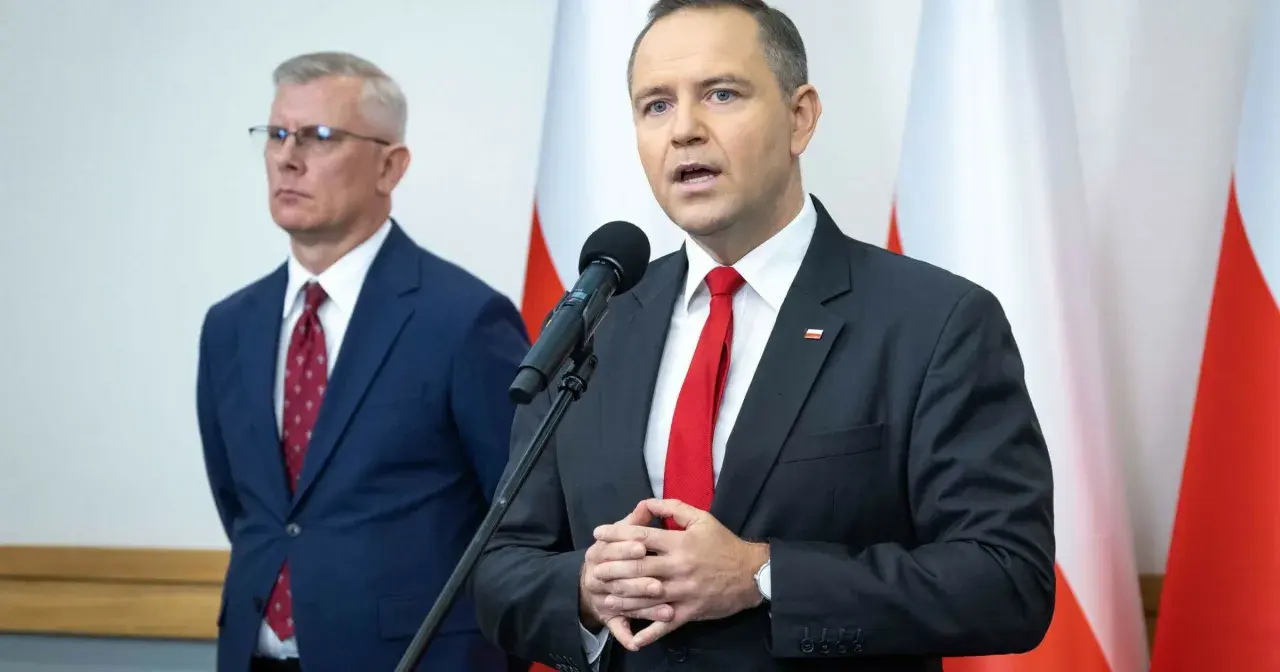 Mężczyzna w garniturze mówi do mikrofonu, obok stoi drugi mężczyzna. Dyskutują, dlaczego prezydent chce zwiększenia budżetu na Biuro Bezpieczeństwa Narodowego o 15 procent.