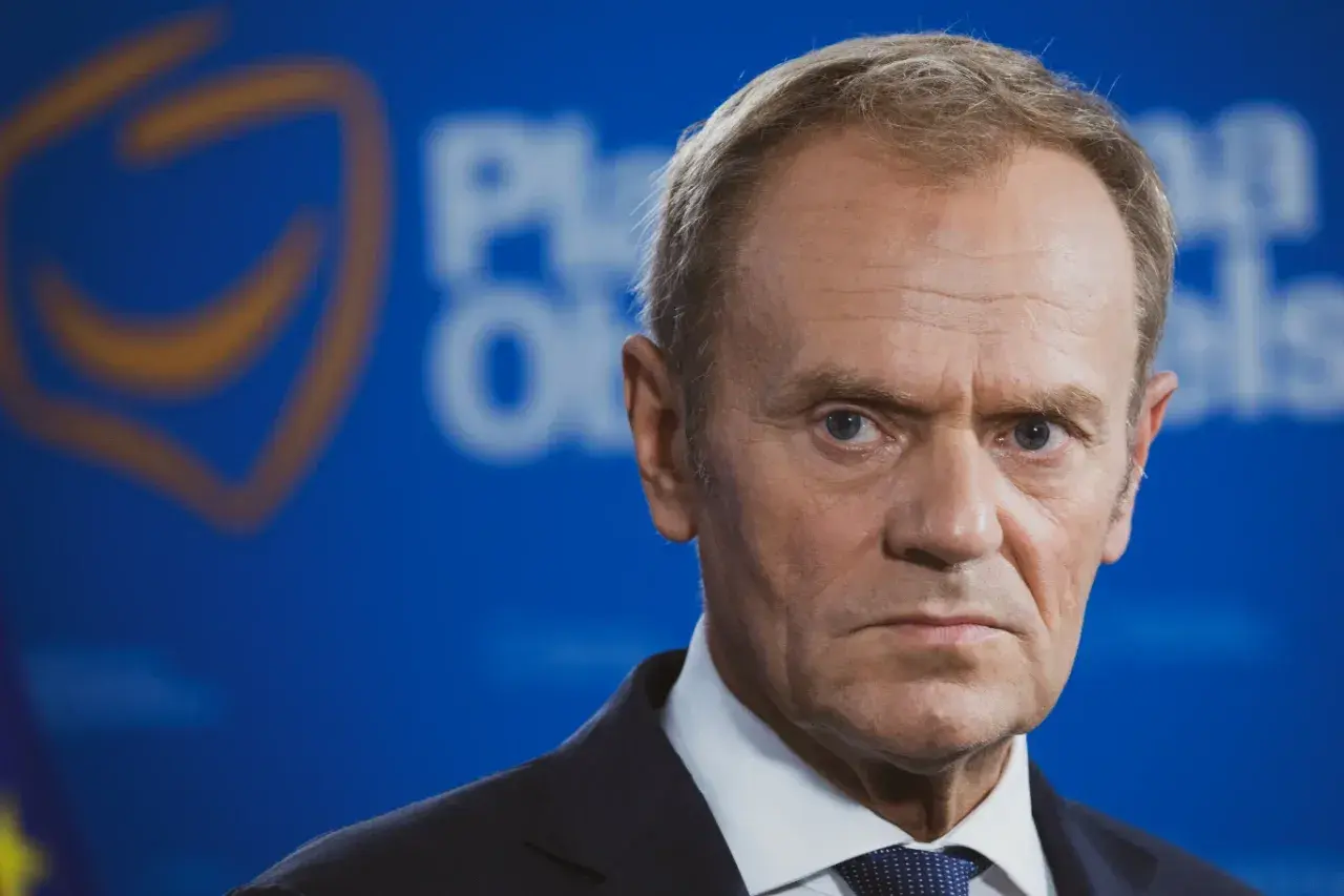 Portret Donalda Tuska na tle niebieskiego banera z logo partii. Kulisy decyzji o jedynej kandydaturze Donalda Tuska na przewodniczącego partii.