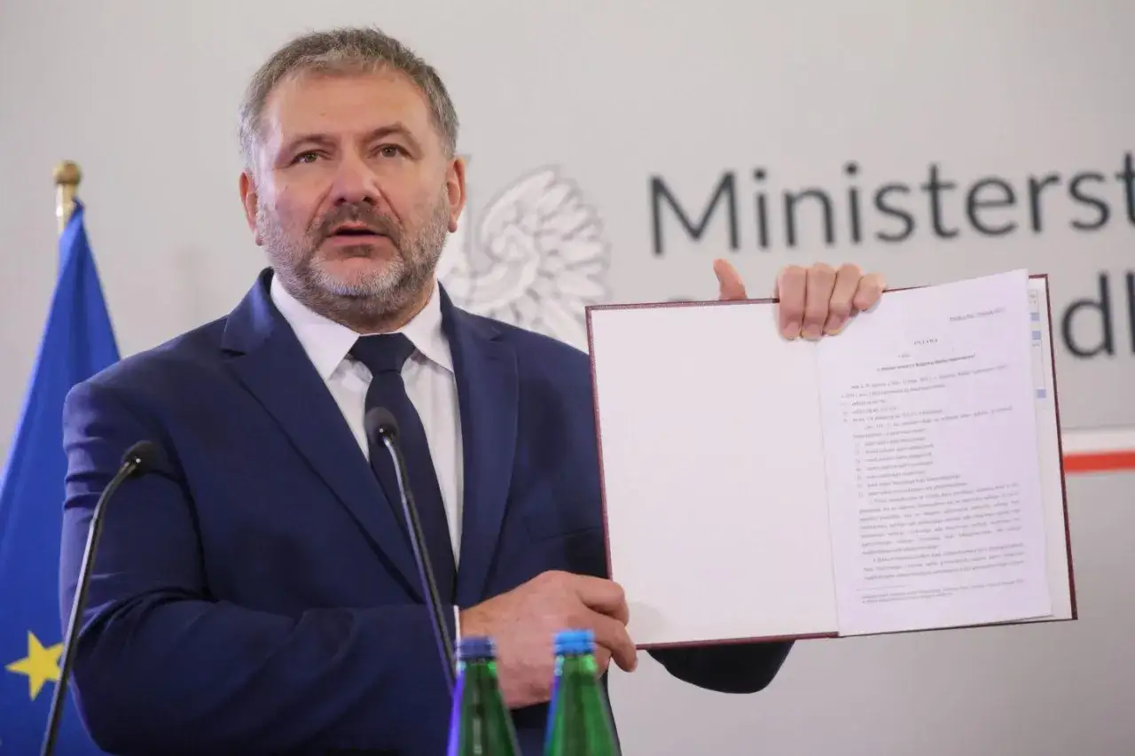 Mężczyzna w garniturze prezentuje dokument, który może dotyczyć prawdziwych przyczyn konfliktu wewnątrz KO o zasady powoływania nowej KRS.