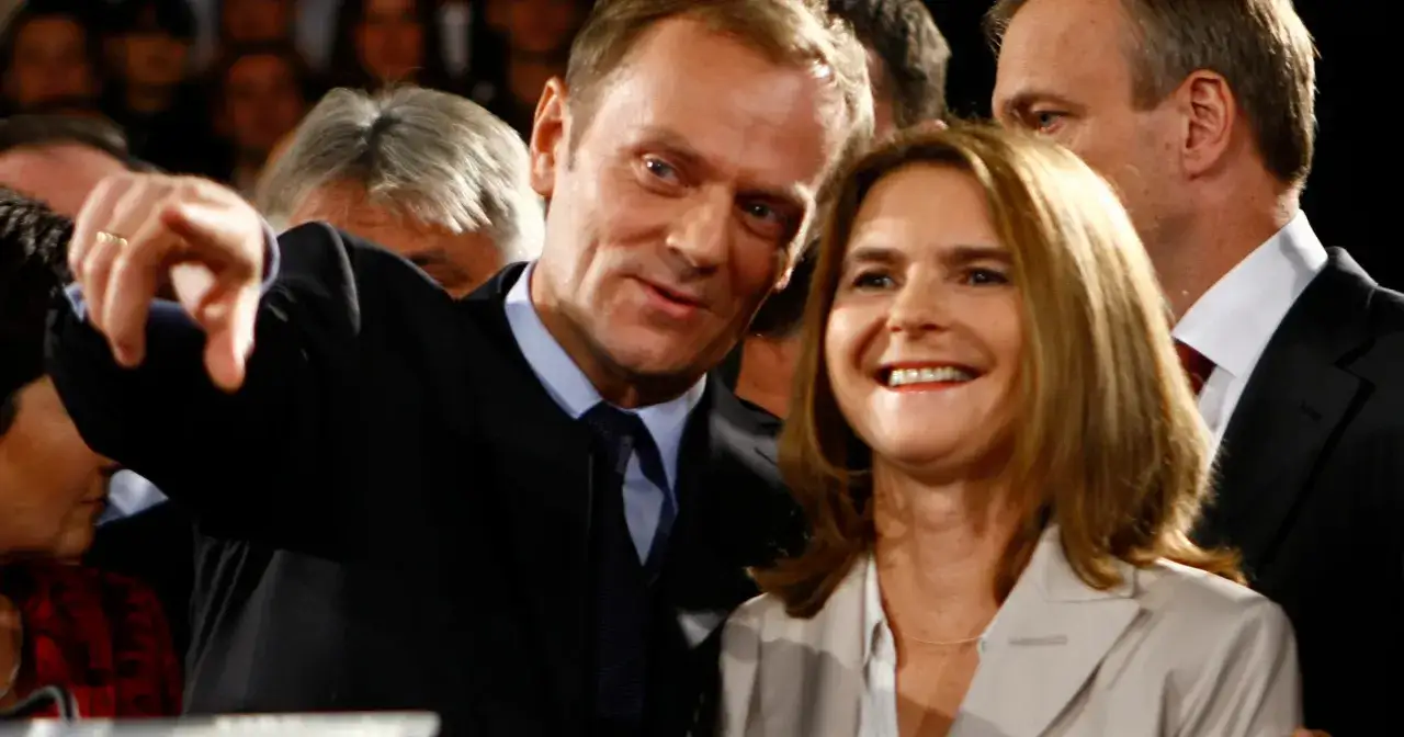 Donald Tusk z żoną, uśmiechnięci, w tłumie.